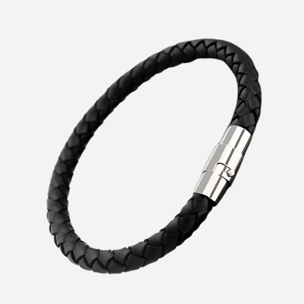 Bracelet cordon de couleurs chaudes noir, sur fond gris clair.