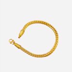 Bracelet doré sur fond rouge.