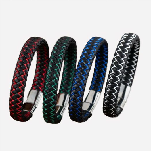 4 bracelets tressés fermé avec un fermoir argenté. Un rouge et noir, un vert et noir, un bleu et noir et un blanc et noir. Ils sont présentés côte à côte sur une planche en bois